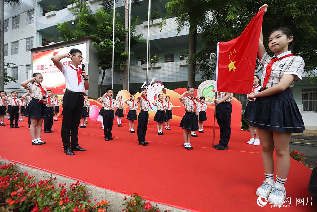 5月31日，在廣西壯族自治區(qū)南寧市民主路小學(xué)，學(xué)校大隊輔導(dǎo)員帶領(lǐng)少先隊員呼號。人民網(wǎng)記者 嚴(yán)立政攝