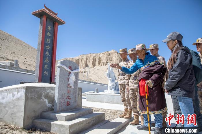 圖為在西藏阿里地區(qū)札達縣烈士陵園，82歲的次仁南杰老人為軍民代表講述新舊西藏的變化?！詵| 攝