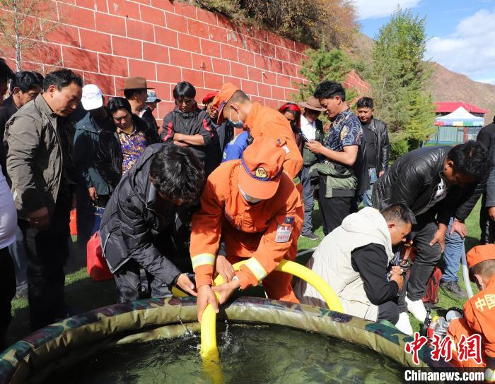 圖為森林消防員為護林員講解滅火裝備的使用方法。　昌都市森林消防支隊 供圖